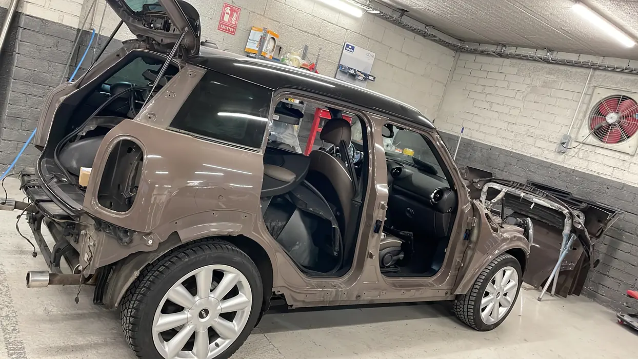 Cotxe desmuntat al taller durant una reparació de carrosseria